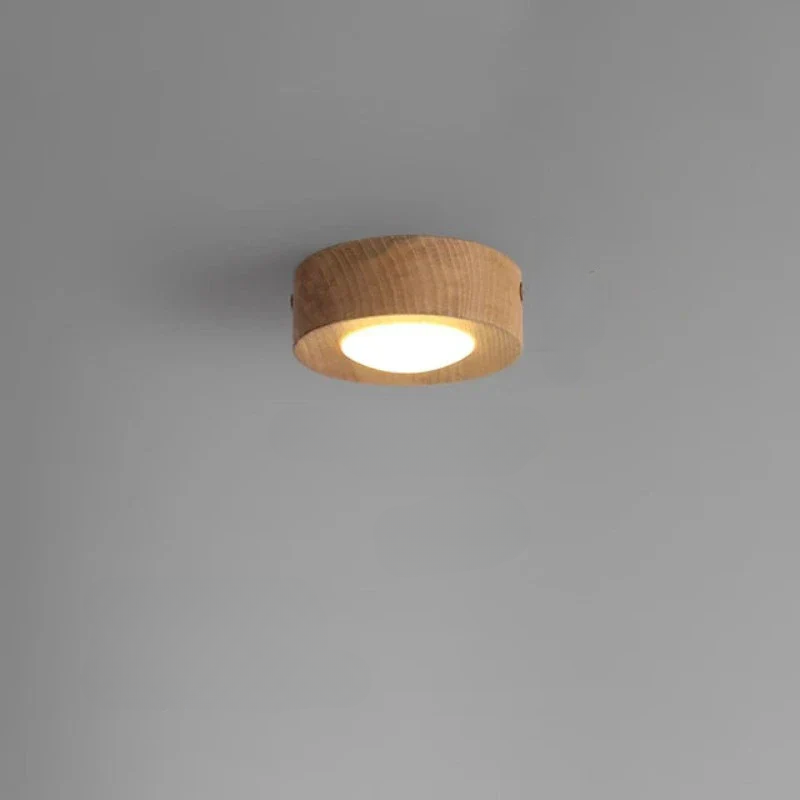 Round wooden ceiling light fixture on a gray background